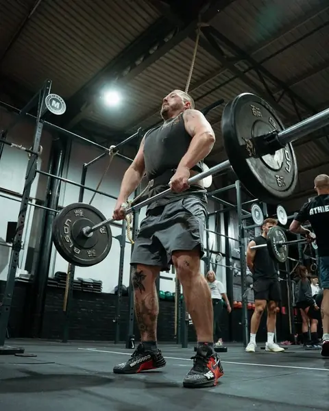 Member lifting a heavy barbell at Mighty Fitness, Durham