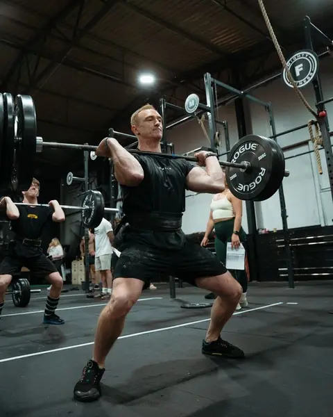 Member front squatting a barbell at Mighty Fitness, Durham