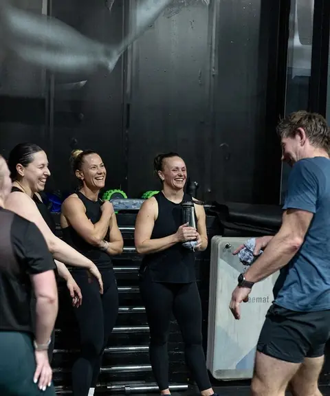 Mighty Fitness members laughing together after a workout